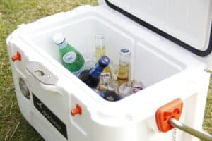 Cooler filled with bagged ice and cold drinks for outdoor events and recreation.